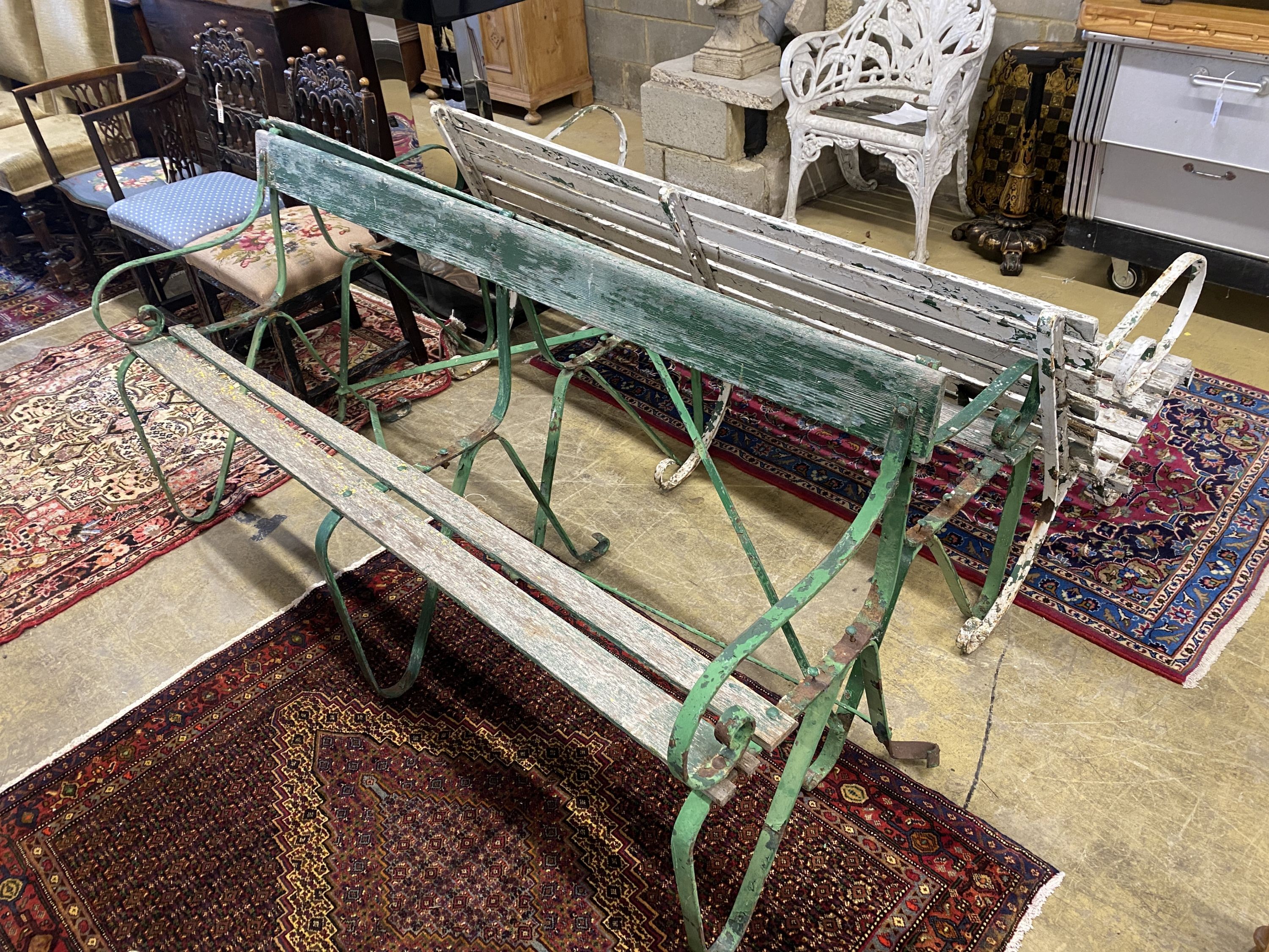 Three various painted wrought iron slatted wood garden benches, two in need of restoration, largest length 176cm, depth 70cm, height 78cm